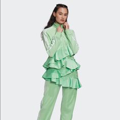 -New, With Original Tags -“Glory Mint” Color -Front Zipper Closure -Silky, Ruffled Detail At Bottom -Velour -Ribbed, Stand Up Collar -Long Sleeve -Satin Frill -79% Cotton, 21% Recycled Polyester Velour Bin100 Trendy Green Track Jacket For Spring, Adidas Green Track Jacket For Spring, Adidas Long Sleeve Track Jacket For Spring, Adidas Long Sleeve Spring Track Jacket, Trendy Fitted Track Jacket For Spring, Spring Adidas Fitted Track Jacket, Adidas Fitted Track Jacket For Spring, Trendy Adidas Outerwear For Spring, Stand Up Collar