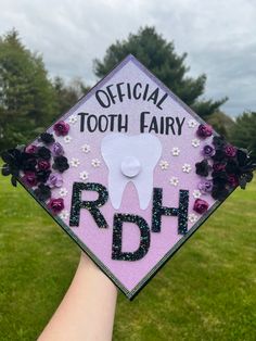 someone holding up a graduation cap that says, official tooth fairy rdh