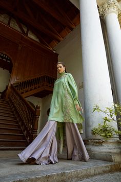 DETAILS Boat neck shirt with a buttoned, side pleat, delicately hand embroidered. Exaggerated balloon sleeves, pleated cuffs, and embellished ties. Paired with a contrasting gharara, pleated edge. Organza dupatta with embroidered motifs and embroidered panels. COLOR Green / Grey SIZE Custom Order - A measurement guide will be sent upon order. Model is 5'7 MATERIAL Shirt - Silk Katan Self JamawarGharara - Raw SilkDupatta - Khaddi Spun Silk Net / Silk Organza PRODUCT CODE 300000-08-28 PRODUCT OF P Boat Neck Shirt, Embroidered Motifs, Organza Dupatta, Silk Organza, Green Grey, Balloon Sleeves, Neck Shirt, Men's Collection, Bosnia And Herzegovina