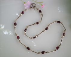 Up for sale is this gorgeous sterling silver rhodolite garnet necklace. It features 13 oval shaped garnets which consist of 4-7 x 4 mm and 9-8 x 4 mm equals 8.75 CT, 28- 4 mm sterling silver round beads, 26 sterling silver spacers and 12- 12 x 2 mm sterling silver bugle beads with toggle clasp. The necklace is 20 inches long and is in very good vintage condition. Please review all images and don't hesitate to ask any questions before purchase and please review my privacy policy for more informat Oval Garnet Necklaces For Anniversary, Oval Garnet Necklace For Anniversary, Herringbone Necklace, Garnet Necklace, Bugle Beads, Rhodolite Garnet, Choker Collar, Adjustable Necklace, Toggle Clasp