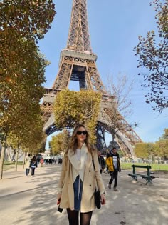 a woman standing in front of the eiffel tower