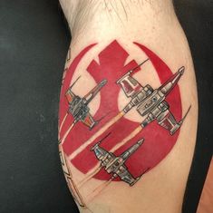 a man's leg with a star wars tattoo on it and an image of fighter jets