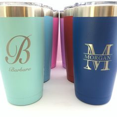 three different colored tumblers sitting next to each other on a white surface with the letter m