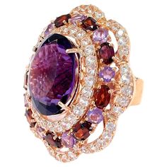 Bochic "Flamenco” Amethyst & Fancy Multi Gems Cocktail Ring 18K Gold & Silver Cluster Multi Color Fancy Gems from Sri Lanka Purple Amethyst - 9 Carat White Topaz - 2 Carat Red Garnet - 3 Carat This Ring is from the "Flamenco” traveling collection are the epitome of elegance and versatility. It offers a perfect blend of day to night and swimwear to evening wear, allowing you to effortlessly transition between different occasions and outfits. Wearing these spectacular oriental-style ring will undo Luxury Amethyst Cabochon Ring For Collectors, Luxury Purple Gemstone Cluster Ring, Luxury Purple Cluster Jewelry, Luxury Cabochon Amethyst Ring Fine Jewelry, Luxury Cabochon Amethyst Ring In Fine Jewelry Style, Luxury Multicolor Amethyst Ring Fine Jewelry, Luxury Multicolor Amethyst Ring, Luxury Multicolor Amethyst Gemstone Ring, Multi Gem Ring