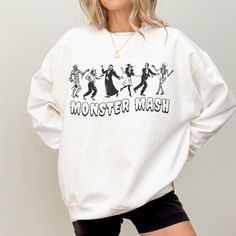 Rock this hauntingly cute Monster Mash Halloween crewneck sweathisrt! Featuring classic Halloween villains in a retro cartoon style, this sweatshirt is perfect for fans of spooky season, the Monster Mash, or anyone who wants a festive look with a touch of nostalgia. Stay spooky and grab yours today!  -50% Cotton 50% Polyester -Loose fit -Sewn in label -Runs true to size (size up for oversized fit) -Inclusive sizing: S-3XL All items are made-to-order: - We do not accept returns, size changes or cancellations. Please read size charts for these items. - Returns and exchanges are only available for damaged or wrong items. Halloween Villains, Retro Cartoon Style, The Monster Mash, Halloween Villain, Halloween Crewneck, Teacher Sweatshirt, Stay Spooky, Classic Halloween, Retro Cartoon