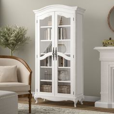 a white cabinet with glass doors in a living room