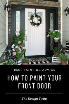 the front door is painted black and white with pink flowers in potted plants on it