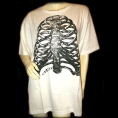 Old Navy New, Never Used/Washed, Mens White T-Shirt Graphic Tee With Black Halloween Human Rib Skeleton Graphic Print - Mens Graphic Tee Shirts. 100% Cotton. Size Xxl. Bust (Pit-Pit) 24-1/2" Across, Length (Shoulder To Hem) 31", Shoulder Width (Back Shoulder-Shoulder) 20-1/2" Across. Mens T-Shirts As Casual Wear, Halloween Attire, Everyday Clothes/Clothing. Seller Code: Prebx-01 White Grunge Tops With Skull Print, White Punk T-shirt With Skull Print, Alternative Style White Skull Print Top, Alternative White Top With Skull Print, White Alternative Style Top With Skull Print, White Skull Print Relaxed Fit T-shirt, White Relaxed Fit T-shirt With Skull Print, Alternative Style Pre-shrunk White T-shirt, Alternative White Cotton T-shirt