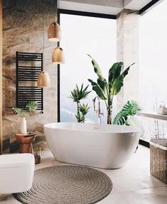 a large white bath tub sitting in a bathroom next to a plant on the floor