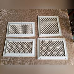 four white window grilles on the floor in front of a wall with leopard print