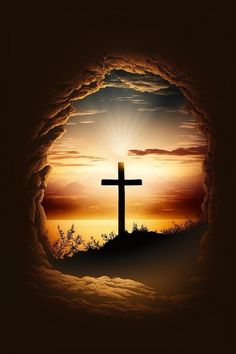 a cross is seen through a hole in the ground as the sun sets behind it