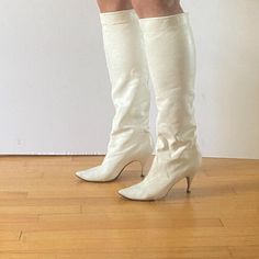 Beautiful and rare vintage 1960s Joseph white leather tall boots with little kitten stiletto heels and pointed toes. Like a very sophisticated gogo boot. The leather is so soft that it's almost stretchy, maybe kid skin (?) and these can be worn pulled to the knee or slouched down. Leather soles. Boots have some general markings and discoloration to the white leather as shown and scuffing mostly at the backs and heels. Approx 9.75" along insole from toe to heel, 2 7/8" across ball of foot, 3.25" heel height. Cream Fitted Boots For Party, Fitted Cream Boots For Party, Fitted Cream Heeled Boots For Party, Cream Colored Fitted Heeled Boots With Pointed Toe, Elegant White Knee-high Boots With Pointed Toe, Classic Fitted Knee-high Boots For Party, Retro Styled Pointed Toe Fitted Heeled Boots, Retro Style Fitted Heeled Boots With Pointed Toe, Retro Fitted Heeled Boots With Pointed Toe