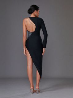 the back of a woman wearing a black dress with high slits and open shoulders