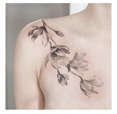 a woman's chest with flowers on it and leaves in the middle of her chest