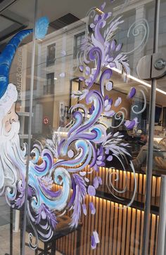 a glass window with an image of a man's head painted on the side