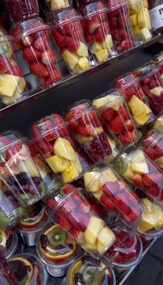 many different types of fruit in plastic containers