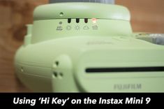 a close up of a camera with the text using hi key on the instax mini 9