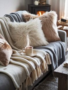 a couch with some pillows and a cup on it