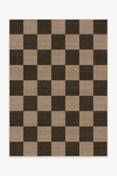 a brown and black checkered rug on top of a white wall