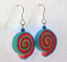 the earrings are decorated with multicolored yarn