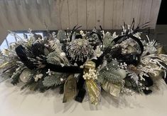 the centerpiece is decorated with silver and black flowers