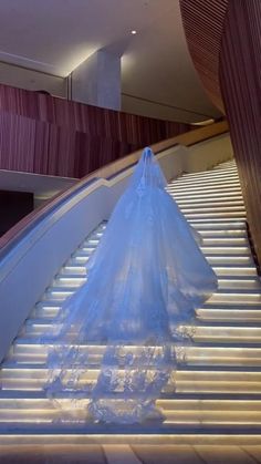 a bride's wedding dress on the escalator