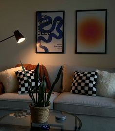 a living room with two couches and a table in front of the couch is decorated with black and white checkered pillows