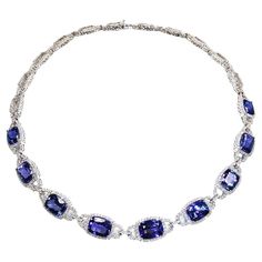 Indulge in the mesmerizing beauty of this exquisite 14 karat white gold necklace featuring a stunning cushion tanzanite pendant. Crafted with exceptional artistry, this necklace showcases the finest quality vivid AAA tanzanite weighing an impressive 35.63 carats. The vibrant purple hues of the tanzanite are perfectly complemented by the radiant sparkle of 4.51 carats of dazzling diamonds, adding an enchanting touch to this timeless piece. With its exceptional design and impeccable gemstone quality, this necklace is a true testament to elegance and sophistication. Discover the allure of rare gemstones at 1stDibs and elevate your jewelry collection to new heights of luxury. Luxury Tanzanite Exquisite Jewelry, Luxury Tanzanite Necklace For Women, Luxury Gold Tanzanite Necklace, Tanzanite Pendant, Tanzanite Necklace, Mesmerizing Beauty, Gold Cushions, White Gold Necklace, Vibrant Purple