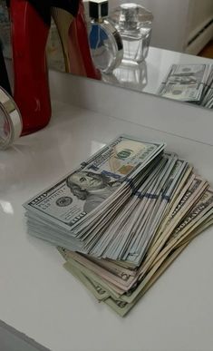 a stack of money sitting on top of a counter