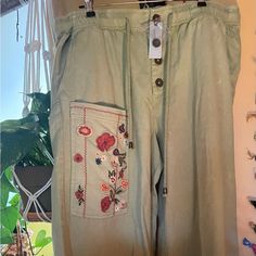 Anthropologie Pilcro Army Green Wide Leg Pants With Large Embroidered Pockets On Front And Back With Both Draw String And Buttoned Waist. These Are Well-Made Soft And Sturdy Pants. Petite Large Nwt Please Note: These Pants Run Large In Leg Width, Length And Overall Fit. I’m 5’1” And These Did Not Feel Petite To Me. Spring Green Embroidered Pants, Spring Wide-leg Pants With Floral Embroidery, Floral Embroidered Wide-leg Pants, Green Floral Print Wide-leg Pants, Green Bohemian Wide Leg Full-length Pants, Army Green, Anthropologie, Wide Leg Pants, Pant Jumpsuit