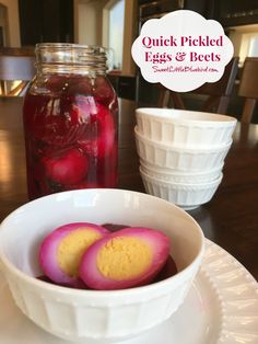 pickled eggs and beets in a white bowl on a plate next to a mason jar