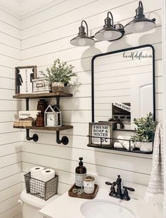 a bathroom with white walls and wooden shelves