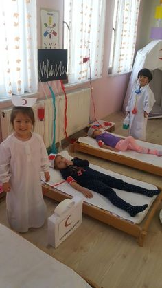 two young children standing next to their beds in a room with balloons and streamers