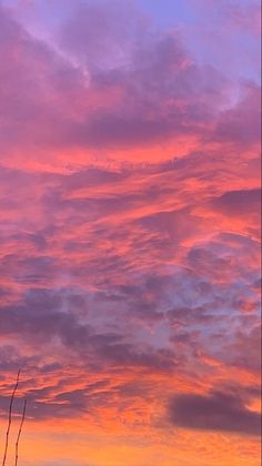 the sky is pink and purple with clouds