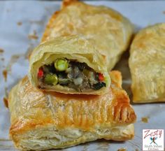 two pastries with meat and vegetables in them