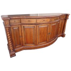 a large wooden buffet table with drawers