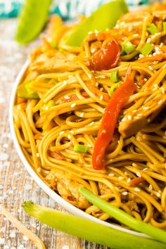 a white plate topped with noodles and vegetables