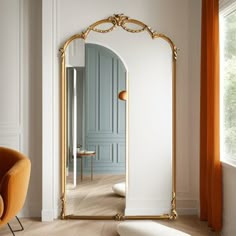 an ornate gold framed mirror in a white living room with orange chairs and a blue door