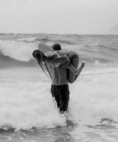 a man carrying a woman on his back in the ocean