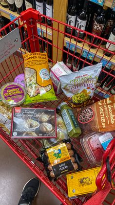 a shopping cart filled with food and condiments