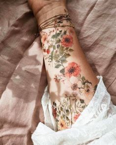 a woman's arm with flowers on it