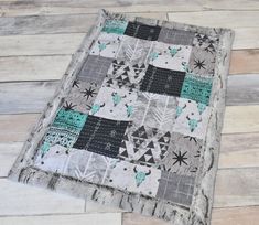 a patchwork table runner made out of old quilts and wood planks on a wooden floor