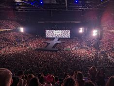 a large crowd at a concert in an arena