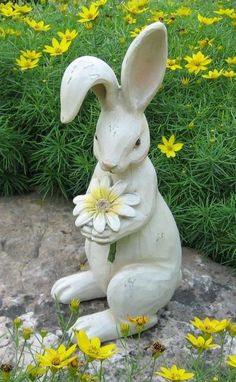 a statue of a rabbit holding a flower