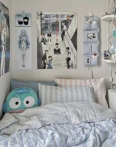 a bed room with a neatly made bed and pictures hanging on the wall above it