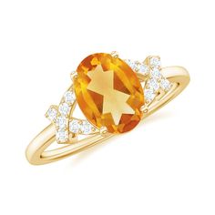 an orange and white ring with diamonds on it's sides, set in yellow gold