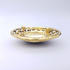 "A lovely early 1900's style brooch featuring a faux black oynx oval center stone surrounded by detailed goldtone filigree flowers and leaves. A beautiful piece for that special vintage outfit or even an addition to a vintage bridal brooch bouquet! Measures 2\" x 1 3/4\" US SHIPPING: US orders over $35 or for 3 or more items ship free via first class mail. Orders over $150 receive a free priority mail upgrade. Expedited shipping is available. SHIPPING OUTSIDE THE US: We combine shipping on multi Luxury Oval Filigree Brooches, Bridal Brooch, Bridal Brooch Bouquet, Types Of Gold, Brooch Bouquet, Vintage Outfit, Gold And Silver Rings, Vintage Bridal, Cord Necklace