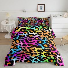 a bed covered in a colorful leopard print comforter