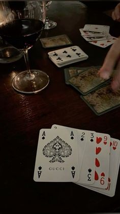 playing cards and wine on a table