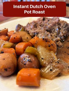 a white plate topped with meat, potatoes and carrots